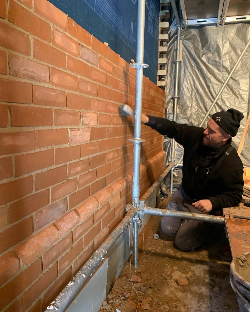 Mason repointing a brick wall on a home in the Greater Toronto Area